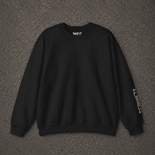 A black crewneck sweatshirt with white graphic text on the inner neck and left sleeve, laid flat on a dark gray asphalt background.