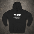 A black pullover hoodie laid flat on a textured gray background, featuring a white graphic print on the chest that reads 'MCC' with 'EST. 2026' and 'MONORCYCLE & CAR CULTURE' below.
