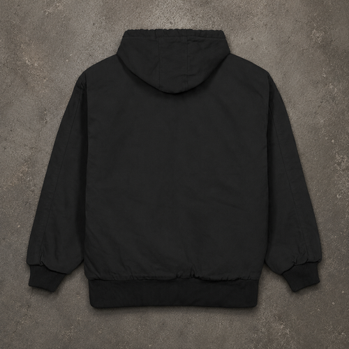 A black hooded jacket shown from the back, laid flat on a textured gray concrete surface.